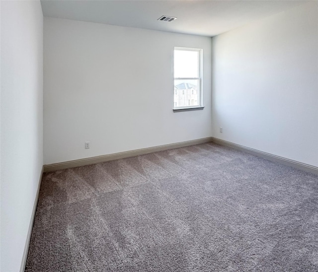 unfurnished room featuring baseboards, visible vents, and carpet floors