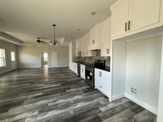 kitchen with a sink, dark wood-style flooring, baseboards, white cabinetry, and appliances with stainless steel finishes