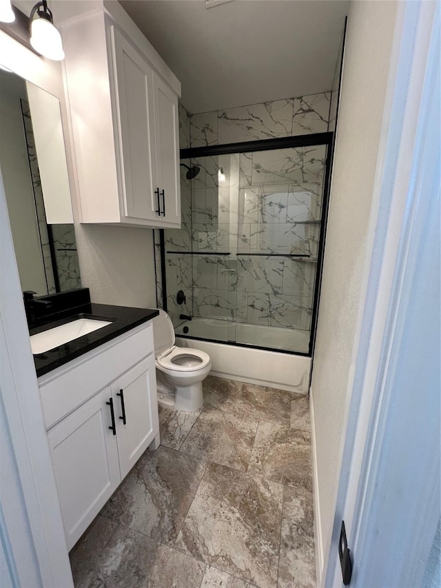 full bath featuring shower / bath combination with glass door, toilet, and vanity