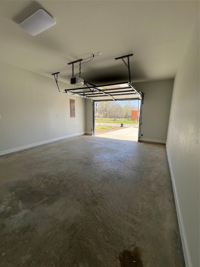 garage with electric panel, baseboards, and a garage door opener