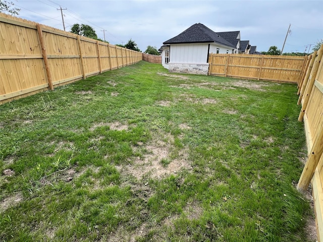 view of yard with a fenced backyard