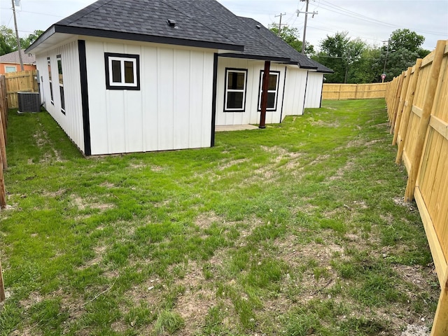 exterior space featuring a fenced backyard and central AC unit