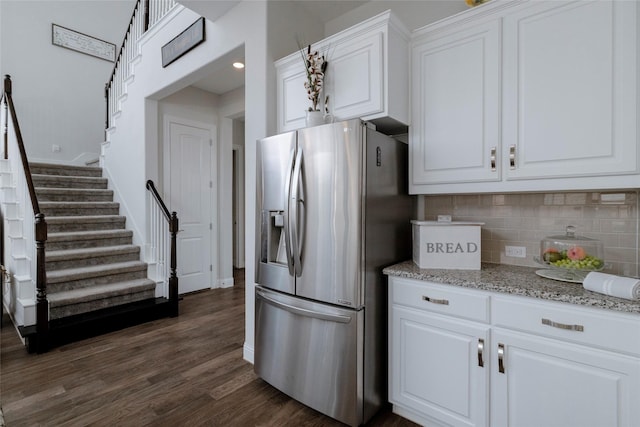 1628 Eleanor Dr, Fort Worth, TX 76052 - kitchen with stainless steel refrigerator with ice dispenser, decorative backsplash, dark wood-type flooring, white cabinetry, and light stone countertops