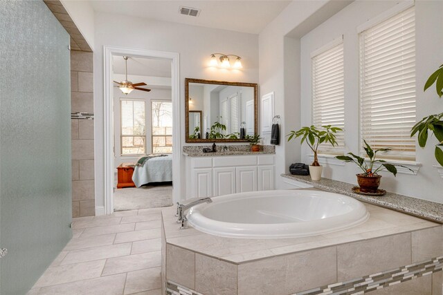 1628 Eleanor Dr, Fort Worth, TX 76052 - bathroom featuring a garden tub, ceiling fan, vanity, tile patterned floors, and connected bathroom