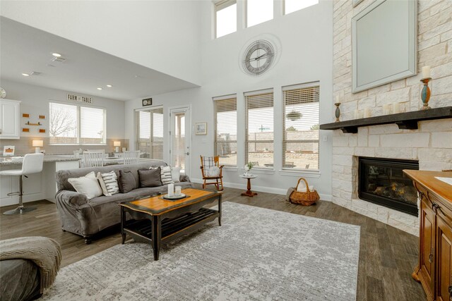 1628 Eleanor Dr, Fort Worth, TX 76052 - living room featuring plenty of natural light, dark wood finished floors, a stone fireplace, recessed lighting, and a high ceiling