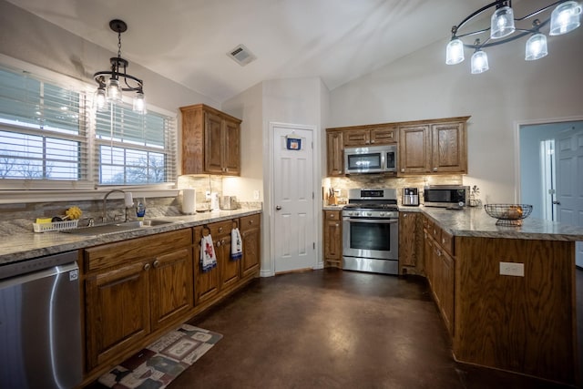 kitchen with visible vents, vaulted ceiling, decorative backsplash, stainless steel appliances, and a sink