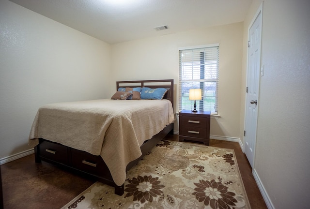 bedroom featuring baseboards and visible vents