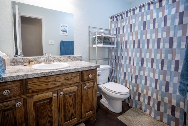 bathroom featuring vanity, curtained shower, and toilet
