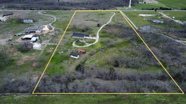 birds eye view of property with a rural view