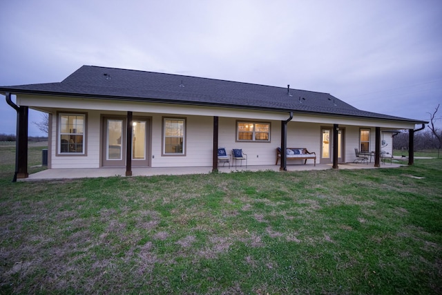 back of house featuring a yard and a patio area