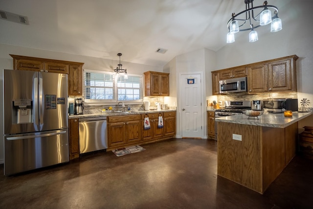 kitchen with a sink, appliances with stainless steel finishes, decorative backsplash, lofted ceiling, and a chandelier