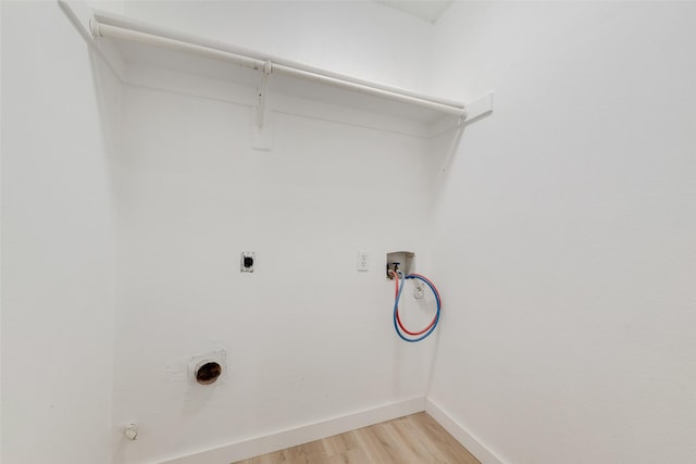 washroom with washer hookup, light wood-style floors, baseboards, hookup for an electric dryer, and laundry area