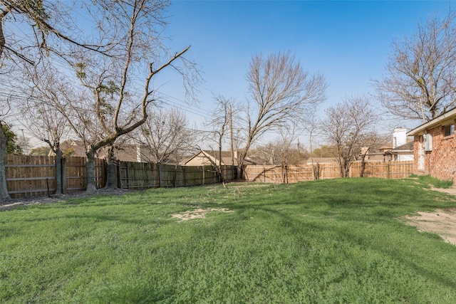 view of yard with a fenced backyard