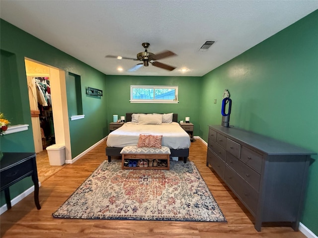 3805 Hastings Dr, Arlington, TX 76013 - bedroom featuring light wood-style floors, a spacious closet, a ceiling fan, and a closet