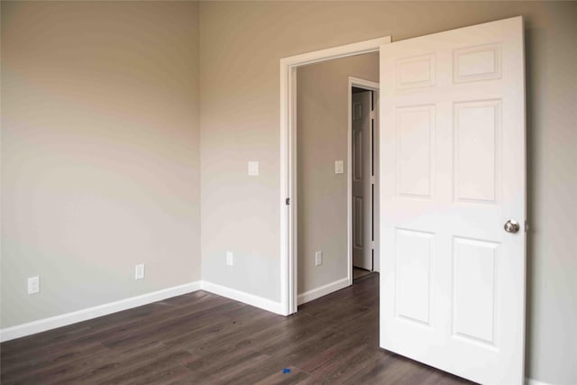 5017 Pickett St, Greenville, TX 75401 - unfurnished bedroom featuring dark wood-style floors and baseboards