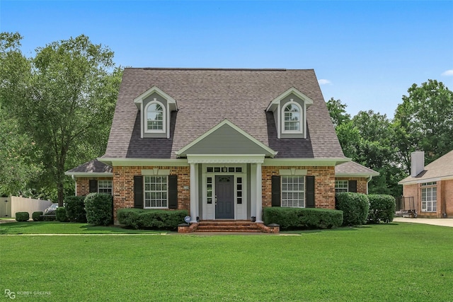 5706 Lake Side Dr, Bossier City, LA 71111 - new england style home with brick siding, a front lawn, and a shingled roof