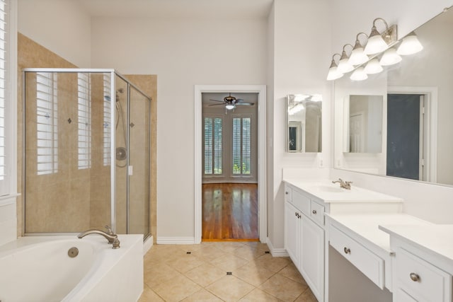 6976 Valley Brook Dr, Frisco, TX 75035 - bathroom with vanity, a stall shower, a bath, a ceiling fan, and tile patterned floors