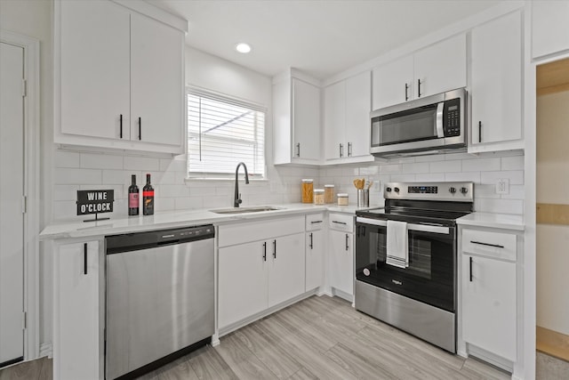 14514 Seagoville Rd, Dallas, TX 75253 - kitchen featuring light countertops, a sink, white cabinetry, and stainless steel appliances