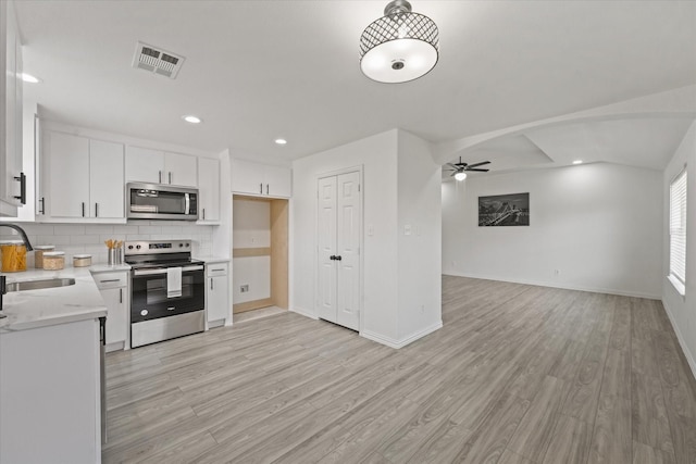 14514 Seagoville Rd, Dallas, TX 75253 - kitchen featuring visible vents, a sink, light countertops, appliances with stainless steel finishes, and light wood-style flooring