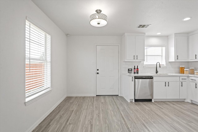 14514 Seagoville Rd, Dallas, TX 75253 - kitchen featuring light countertops, visible vents, stainless steel dishwasher, light wood finished floors, and a sink