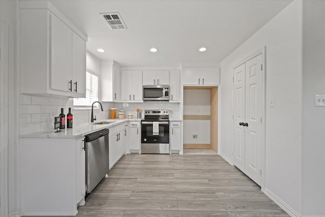 14514 Seagoville Rd, Dallas, TX 75253 - kitchen featuring visible vents, a sink, light countertops, appliances with stainless steel finishes, and recessed lighting