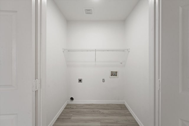 14514 Seagoville Rd, Dallas, TX 75253 - washroom with laundry area, hookup for a washing machine, visible vents, hookup for an electric dryer, and light wood finished floors