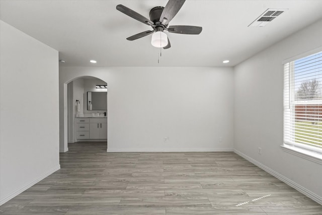 14514 Seagoville Rd, Dallas, TX 75253 - empty room featuring arched walkways, ceiling fan, visible vents, and a wealth of natural light