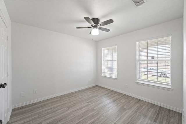 14514 Seagoville Rd, Dallas, TX 75253 - spare room featuring visible vents, baseboards, a ceiling fan, and light wood-style flooring