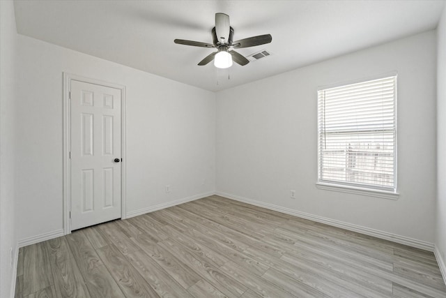 14514 Seagoville Rd, Dallas, TX 75253 - empty room with visible vents, light wood-style flooring, ceiling fan, and baseboards