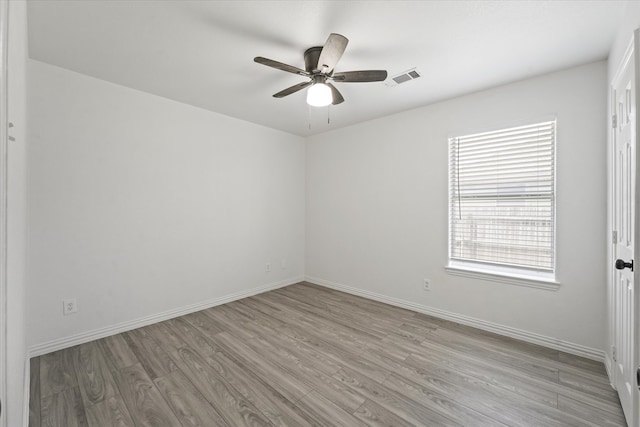 14514 Seagoville Rd, Dallas, TX 75253 - spare room featuring light wood-style flooring, a healthy amount of sunlight, and a ceiling fan