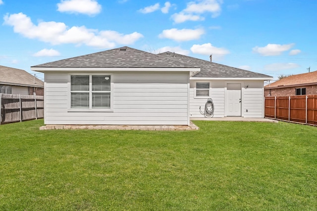 14514 Seagoville Rd, Dallas, TX 75253 - rear view of house featuring a yard, a fenced backyard, and a shingled roof