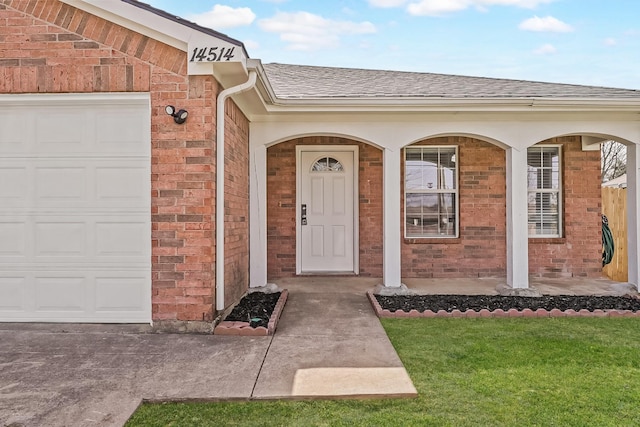 14514 Seagoville Rd, Dallas, TX 75253 - entrance to property featuring an attached garage, a porch, brick siding, a shingled roof, and a lawn