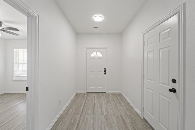 14514 Seagoville Rd, Dallas, TX 75253 - doorway featuring visible vents, baseboards, light wood-type flooring, and a ceiling fan