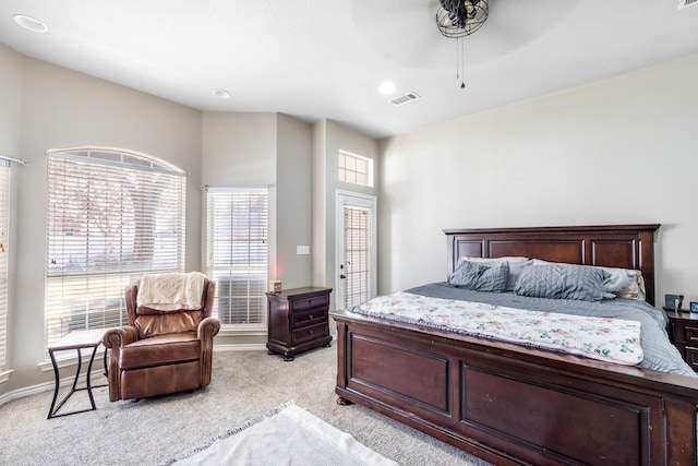 bedroom featuring visible vents, a ceiling fan, baseboards, and light carpet