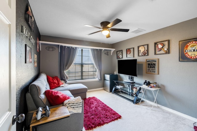 carpeted living room with visible vents, baseboards, and a ceiling fan