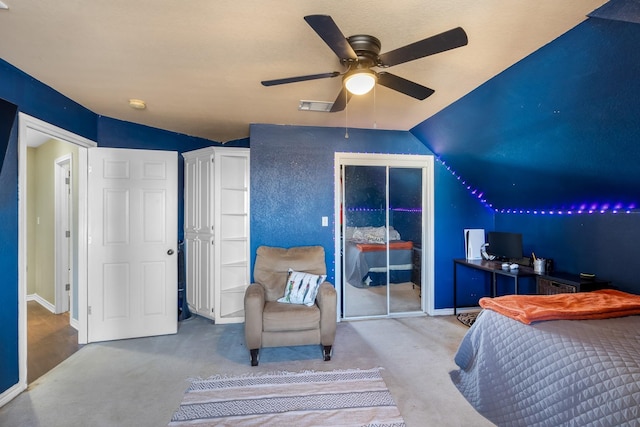 carpeted bedroom with visible vents, lofted ceiling, and ceiling fan