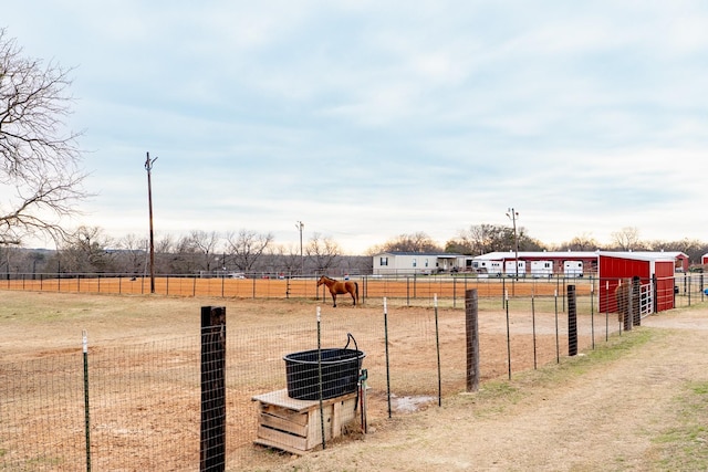 view of yard with a rural view and fence