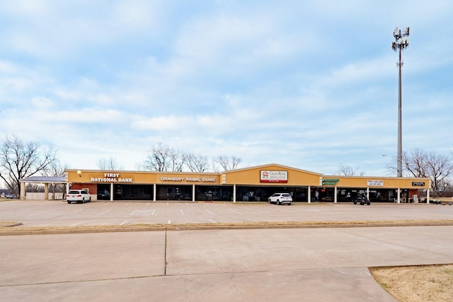 view of building exterior with uncovered parking