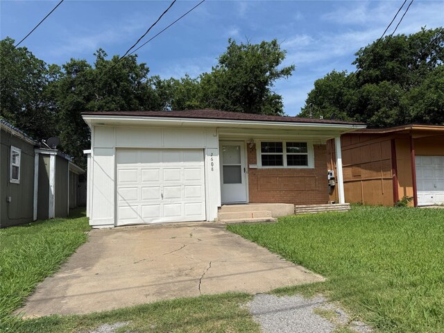 2608 N Hickory St, Sherman, TX 75092 - view of front of house with a garage, a front yard, concrete driveway, and brick siding
