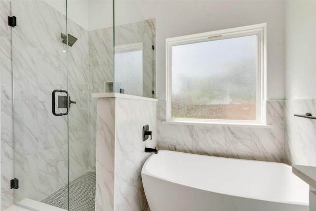 4515 Eutopia St, Greenville, TX 75401 - bathroom featuring tile walls, a marble finish shower, and a freestanding tub