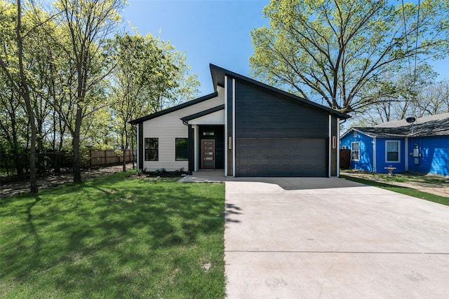 4515 Eutopia St, Greenville, TX 75401 - mid-century inspired home featuring concrete driveway, a front yard, fence, and a garage