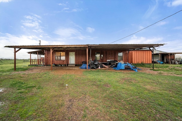 view of pole building with a lawn and a carport