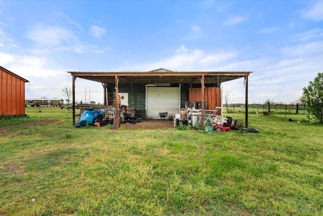 view of pole building featuring a lawn and fence