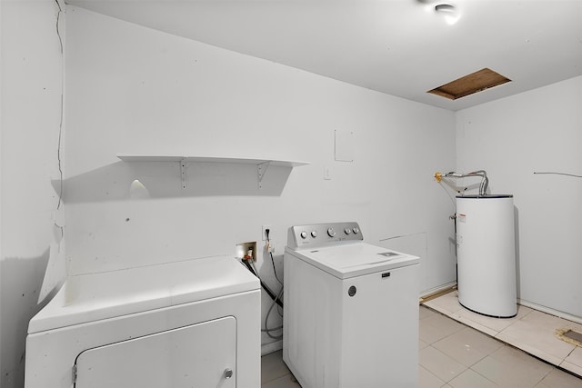 clothes washing area with water heater, washing machine and clothes dryer, light tile patterned floors, and laundry area