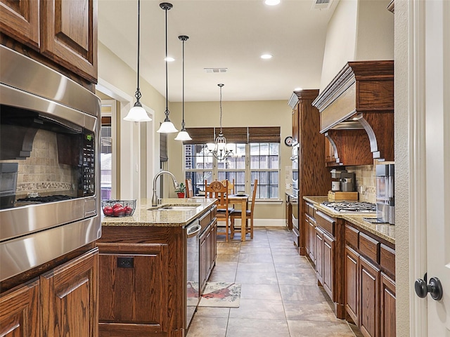 741 Butchart Dr, Prosper, TX 75078 - kitchen with a sink, appliances with stainless steel finishes, tasteful backsplash, recessed lighting, and a chandelier