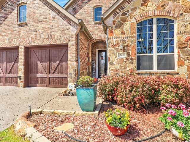 741 Butchart Dr, Prosper, TX 75078 - view of front of house with stone siding, brick siding, and concrete driveway