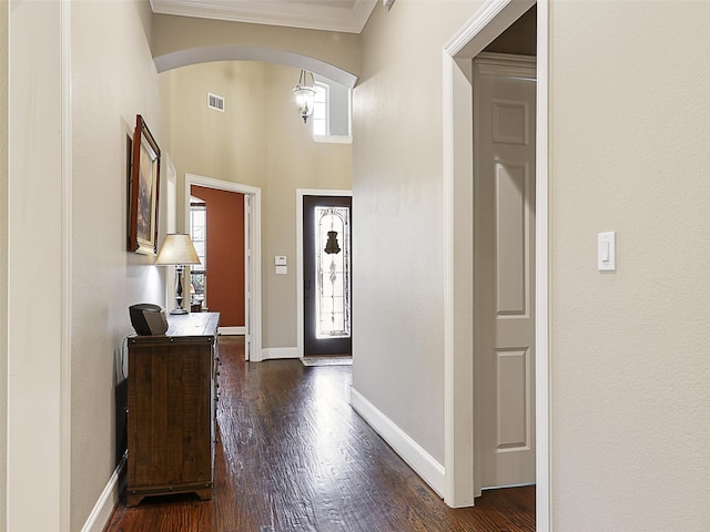 741 Butchart Dr, Prosper, TX 75078 - foyer entrance with arched walkways, healthy amount of natural light, ornamental molding, and dark wood-style floors