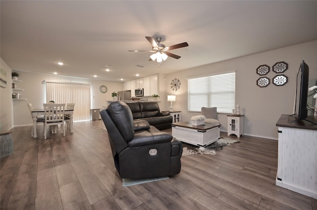 living room with dark wood-type flooring, recessed lighting, a ceiling fan, and baseboards