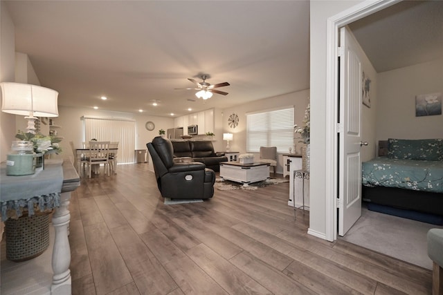 living area featuring recessed lighting, a ceiling fan, and wood finished floors