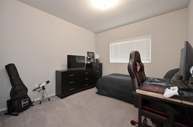 bedroom featuring light carpet, a textured ceiling, and baseboards